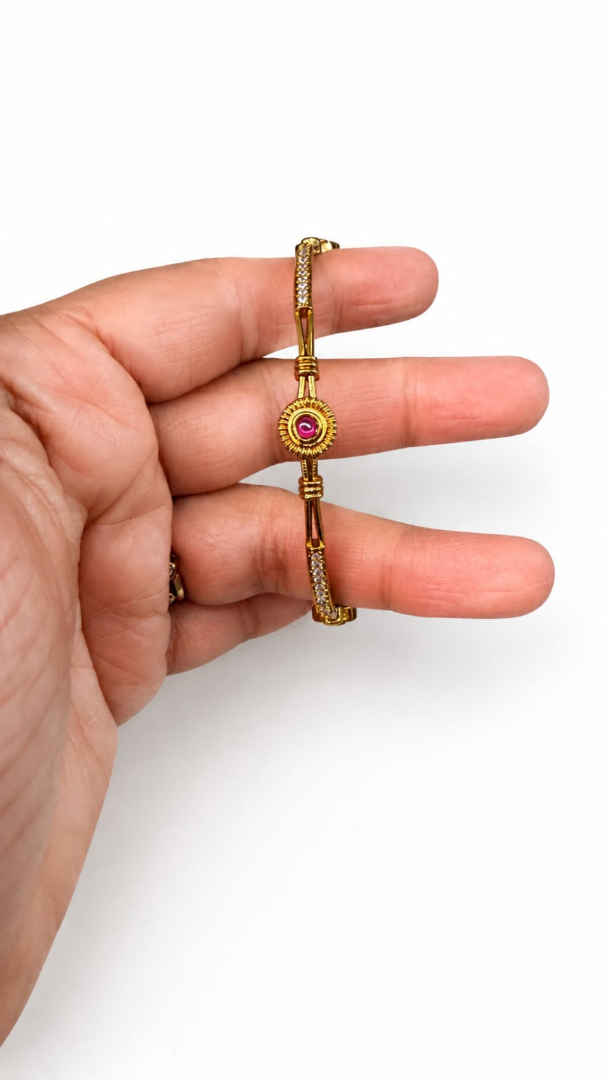 Ruby face of Ruby and Green crystal medallion gold-tone bangle