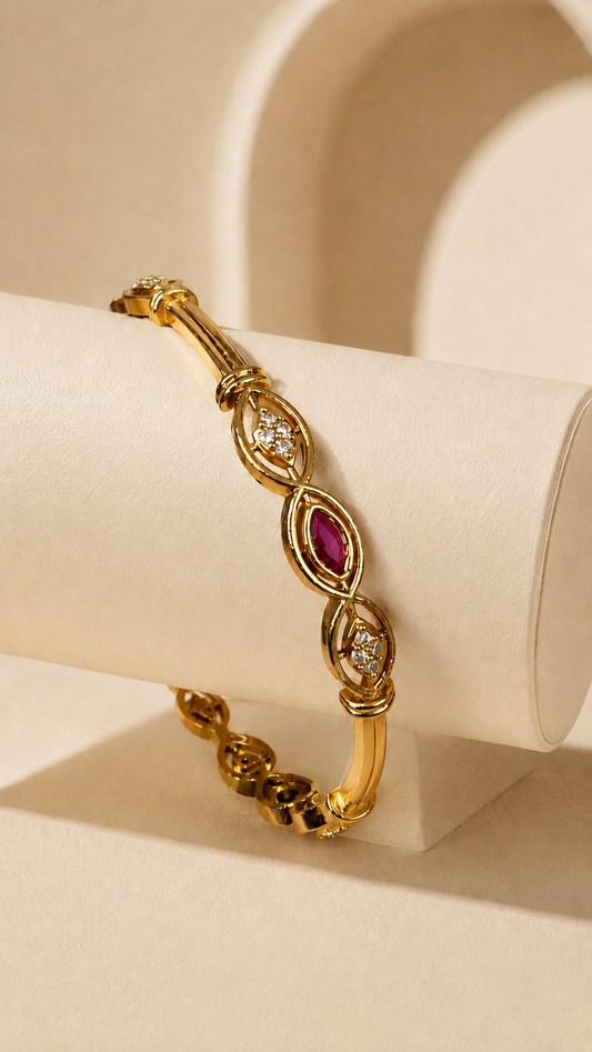 Gold-tone bangle with marquise-shaped ruby crystal accents from Belumiee, stylish jewelry accessory.