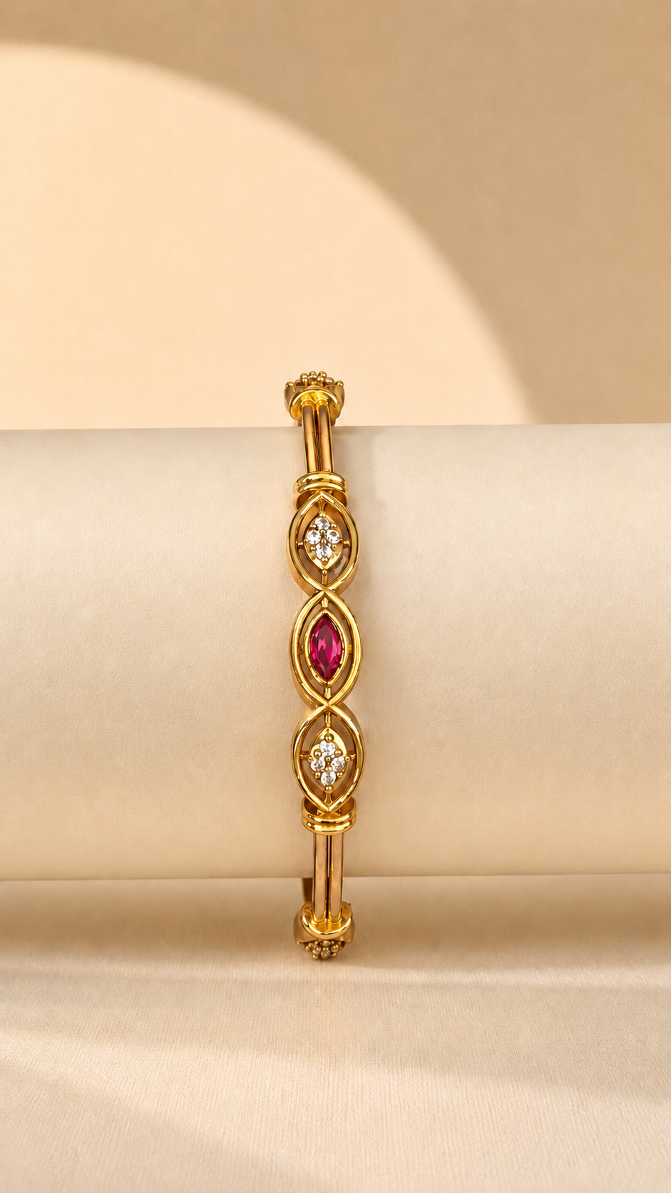 Belumiee Ruby Marquise Crystal Gold-Tone Bangle featuring marquise-shaped red crystals on a shiny gold-tone bracelet.