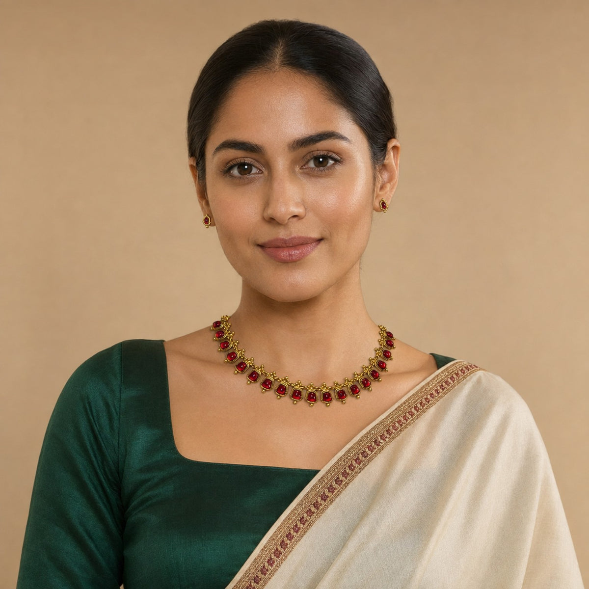 Traditional Belumiee gemstone gold-tone necklace set with ruby-red gemstones, featuring intricate design and matching earrings.