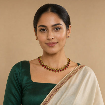 Traditional Belumiee gemstone gold-tone necklace set with ruby-red gemstones, featuring intricate design and matching earrings.