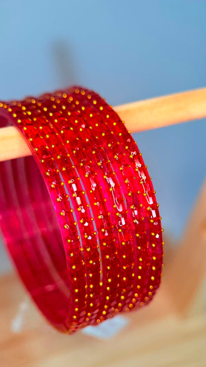 Pink ruby glass bangles set by Belumiee featuring sparkling, decorative bangles perfect for traditional or festive wear.