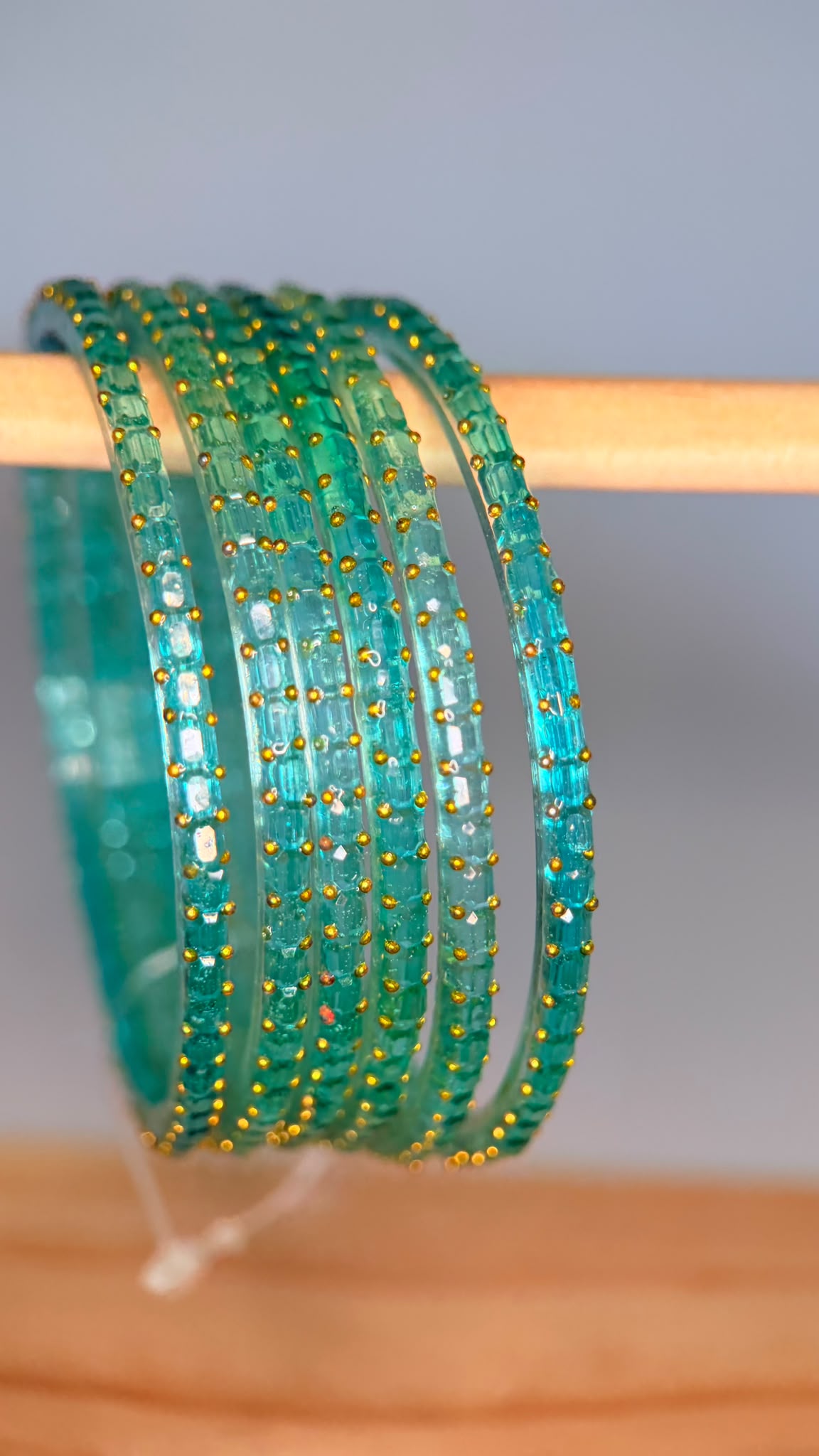Sea green Navrang Sparkle Glass Bangles Set by Belumiee, showcasing shiny, decorative glass bangles on a neutral background.