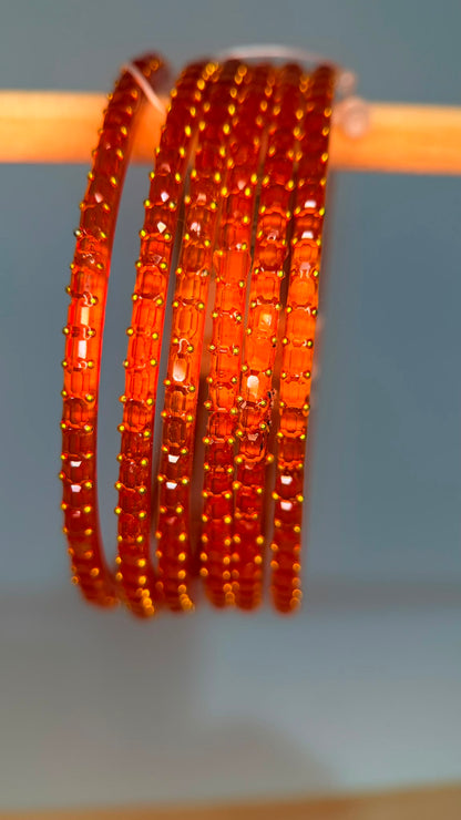 Tangerine orange Navrang Sparkle Glass Bangles Set by Belumiee, featuring shimmering glass bangles with intricate detailing.