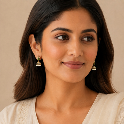 Model wearing emerald green teardrop crystal mini jhumka earrings