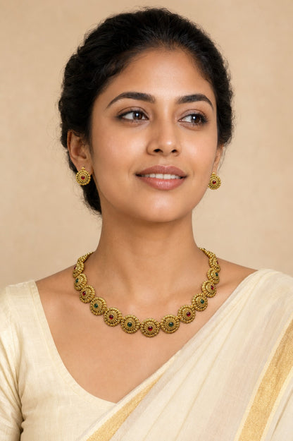 Traditional Ruby and Emerald Floral Disc Necklace Set by Belumiee, featuring vibrant gemstones and intricate design.