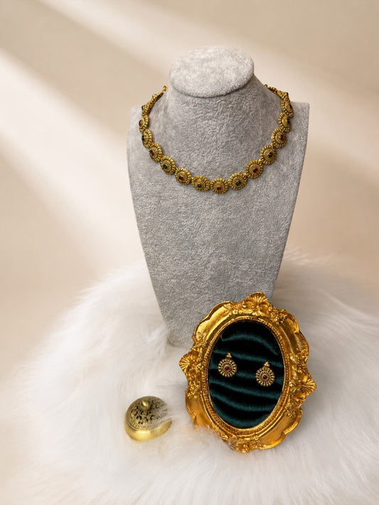 Traditional Ruby and Emerald Floral Disc Necklace Set by Belumiee, featuring intricate jewelry with vibrant red and green gemstones.